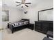 Bedroom showcasing a sleek black furniture set with striped bedding and decorative wall art at 5494 White Cedar Ter, Sugar Hill, GA 30518