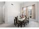 Elegant dining room with modern table and chairs, enhanced by natural light from large windows at 5494 White Cedar Ter, Sugar Hill, GA 30518