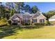 Charming brick home with a well-manicured lawn, complemented by mature trees and manicured shrubs at 5494 White Cedar Ter, Sugar Hill, GA 30518