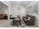 Inviting living room with vaulted ceilings, a comfortable sofa, and a daybed, creating a versatile and welcoming space at 5494 White Cedar Ter, Sugar Hill, GA 30518