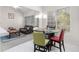 Cozy living area featuring large windows, a glass table, and an adjacent sitting space, ideal for relaxation and entertainment at 5494 White Cedar Ter, Sugar Hill, GA 30518