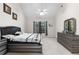 Bright main bedroom featuring neutral tones, large windows, and elegant decor, creating a peaceful and inviting atmosphere at 5494 White Cedar Ter, Sugar Hill, GA 30518