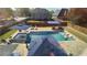 Aerial view of a luxury backyard pool, featuring lounge chairs and a lounge area, ideal for relaxation and entertainment at 4118 Sandy Branch Dr, Buford, GA 30519