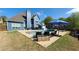Inviting backyard pool area featuring a blue house, a stone patio, and comfortable outdoor seating at 4118 Sandy Branch Dr, Buford, GA 30519