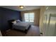 Cozy bedroom featuring a comfortable bed, soft carpet, and a large window at 4118 Sandy Branch Dr, Buford, GA 30519
