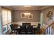 Elegant dining room with modern chandelier, wainscoting, and natural light at 4118 Sandy Branch Dr, Buford, GA 30519