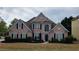 Beautiful brick home with a manicured lawn and dark shutters at 4118 Sandy Branch Dr, Buford, GA 30519