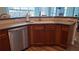 Functional kitchen with stainless steel dishwasher and wood cabinets at 4118 Sandy Branch Dr, Buford, GA 30519