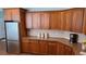 Classic kitchen with wood cabinetry and stainless steel refrigerator at 4118 Sandy Branch Dr, Buford, GA 30519