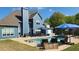 Inviting backyard pool area featuring a blue house, a stone patio, and comfortable outdoor seating at 4118 Sandy Branch Dr, Buford, GA 30519