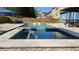 Luxury backyard pool with a stone border, blue umbrella, and relaxing lounge area, perfect for summer days at 4118 Sandy Branch Dr, Buford, GA 30519