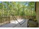 Exterior view of a wooden back deck featuring a hammock and a plant box at 135 Fiddle Crk, Social Circle, GA 30025