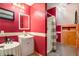 Bathroom featuring bright red walls, a shower, and a white vanity at 135 Fiddle Crk, Social Circle, GA 30025