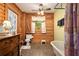 Bathroom with log walls, claw foot tub and stained-glass window at 135 Fiddle Crk, Social Circle, GA 30025