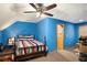 Upstairs bedroom with blue painted walls and peaked ceilings at 135 Fiddle Crk, Social Circle, GA 30025