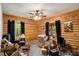 Bedroom with log walls, large windows, carpeted floor and a ceiling fan at 135 Fiddle Crk, Social Circle, GA 30025