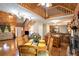 Open dining area with hardwood floors, stone fireplace, and access to the kitchen and living room at 135 Fiddle Crk, Social Circle, GA 30025