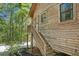 Side view of the home showcasing a wooden staircase to the home's entrance at 135 Fiddle Crk, Social Circle, GA 30025