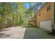 Exterior of the house showcasing a well-maintained yard with a partial view of a garage at 135 Fiddle Crk, Social Circle, GA 30025