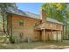 Exterior of the house featuring a garage, balcony, and mature trees at 135 Fiddle Crk, Social Circle, GA 30025
