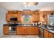 Kitchen featuring stainless steel appliances, dark countertops, and custom cabinetry at 135 Fiddle Crk, Social Circle, GA 30025