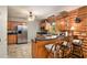 Kitchen featuring a breakfast bar with seating, stainless steel appliances, and light wood cabinetry at 135 Fiddle Crk, Social Circle, GA 30025