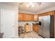 Kitchen with stainless steel appliances, custom cabinetry, tiled floor, and white door at 135 Fiddle Crk, Social Circle, GA 30025