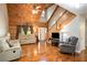 Open living room featuring wood paneled vaulted ceilings, hardwood floors, and natural light at 135 Fiddle Crk, Social Circle, GA 30025