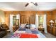 Charming log-walled bedroom featuring a decorative bed and quaint furnishings at 135 Fiddle Crk, Social Circle, GA 30025