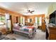 Cozy log-walled bedroom with a colorful quilt bed and comfortable furnishings at 135 Fiddle Crk, Social Circle, GA 30025