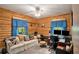 Office with log walls, carpeted floor, a ceiling fan and windows providing natural light at 135 Fiddle Crk, Social Circle, GA 30025