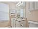 Bathroom with granite countertop, stylish cabinets, and a large mirror at 2557 Summit Cove Dr # 128, Duluth, GA 30097
