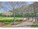 Fenced dog park with grassy areas, trees, and amenities for pets and their owners at 2557 Summit Cove Dr # 128, Duluth, GA 30097