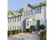 Inviting townhouse with stone facade, green shutters, and manicured landscaping enhancing curb appeal at 2557 Summit Cove Dr # 128, Duluth, GA 30097