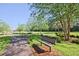 Scenic park view with a paved trail, bench, lush greenery, and mature trees for a peaceful outdoor experience at 2557 Summit Cove Dr # 128, Duluth, GA 30097