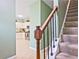 View of staircase from kitchen with wood railing, carpet steps, and open layout to living space at 2557 Summit Cove Dr # 128, Duluth, GA 30097
