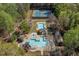 Aerial view of community amenities including pools, cabanas, and tennis courts surrounded by lush greenery at 2850 Dartmouth Pl, Cumming, GA 30041