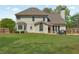 Expansive backyard featuring a lush lawn, patio space, and fenced perimeter for added privacy at 2850 Dartmouth Pl, Cumming, GA 30041