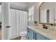 Stylish bathroom with blue vanity, shower with curtain, and modern fixtures at 2850 Dartmouth Pl, Cumming, GA 30041