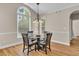 Cozy dining area with hardwood floors, a chandelier, and large windows providing natural light at 2850 Dartmouth Pl, Cumming, GA 30041