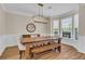 Dining room boasts natural light, a stylish light fixture, wainscoting, and hardwood floors at 2850 Dartmouth Pl, Cumming, GA 30041