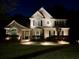 Elegant home exterior at night, showcasing professional landscape lighting and architectural details at 2850 Dartmouth Pl, Cumming, GA 30041