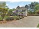 Charming two-story home with a stone facade, manicured landscaping, and a spacious driveway at 2850 Dartmouth Pl, Cumming, GA 30041