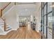 Bright foyer featuring a staircase, hardwood floors, and an open view into the living room at 2850 Dartmouth Pl, Cumming, GA 30041