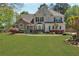 Charming two-story home with stone accents, a well-manicured lawn, and professional landscaping at 2850 Dartmouth Pl, Cumming, GA 30041