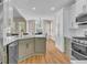 Modern kitchen with white cabinetry, stainless steel appliances, and an adjacent dining area at 2850 Dartmouth Pl, Cumming, GA 30041