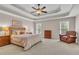 Spacious main bedroom with tray ceiling, large bed, and comfortable sitting area at 2850 Dartmouth Pl, Cumming, GA 30041