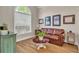 Sitting room features wood flooring, large window and comfortable leather couch at 2850 Dartmouth Pl, Cumming, GA 30041
