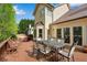 A back deck with outdoor table and chairs with view of the house exterior at 3665 Evonvale Gln, Cumming, GA 30041