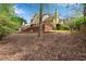 The exterior of the home features a spacious deck and lush lawn bordered by mature trees, blending indoor and outdoor living at 3665 Evonvale Gln, Cumming, GA 30041